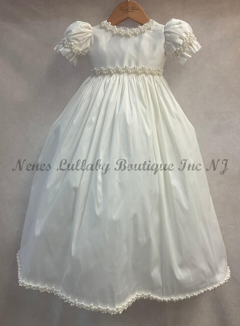 100% white silk dress accented with pearl at neckline, waist & victorian sleeve 