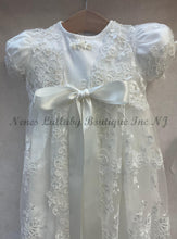 Load image into Gallery viewer, hite lace dress with a large bow on a gray background