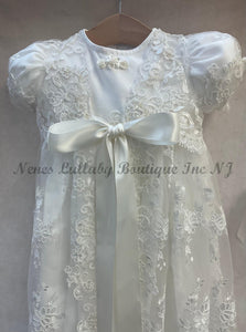 hite lace dress with a large bow on a gray background