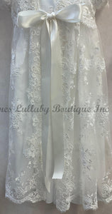 Lace garment with a large bow on a plain background