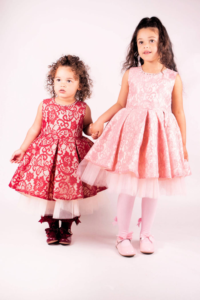 881731 Girls lace dress with white net tutu underneath, bead and diamanté around collar, complete with a bow on the back.